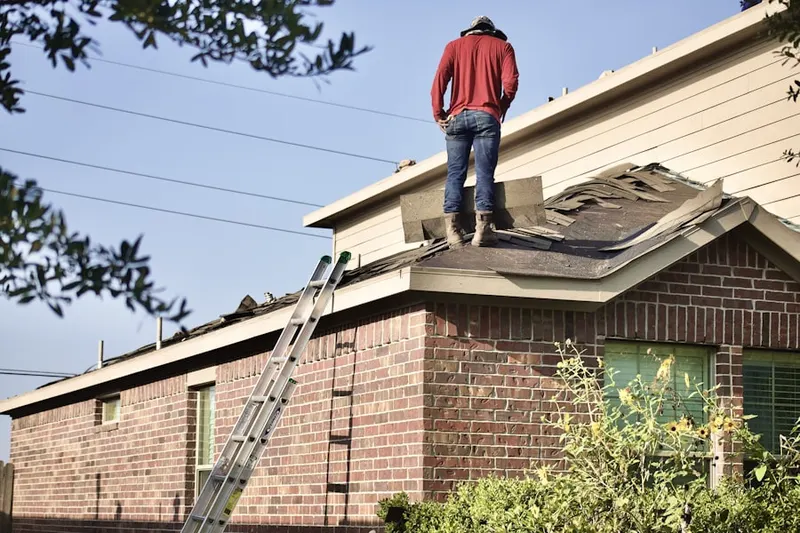 Professional roofer working on a residential roof in Lincklaen Center